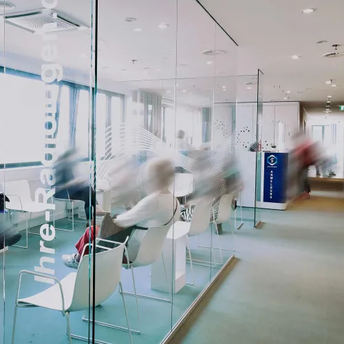 Waiting area with modern glass walls and pleasant lighting.